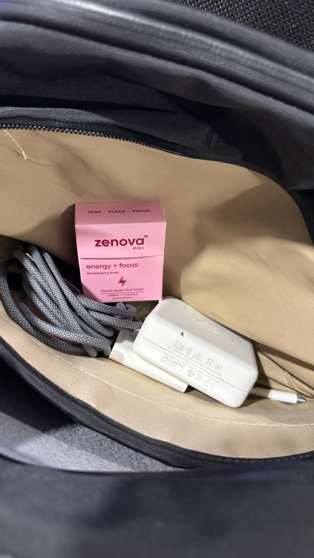 Zenova box tucked in a bag with a charger